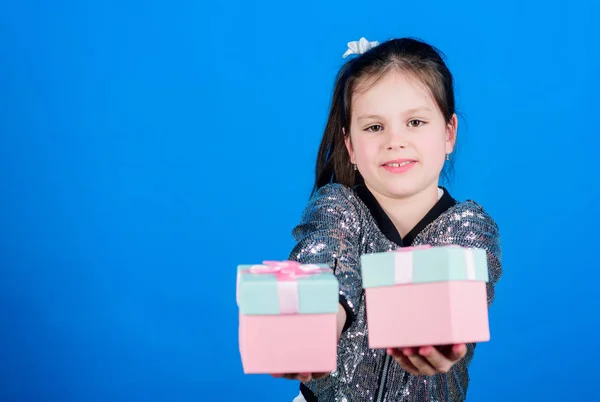 Girl with gift boxes blue background. Black friday. Shopping day. Cute child carry gift boxes. Surprise gift box. Birthday wish list. World of happiness. Special happens every day. Choose one