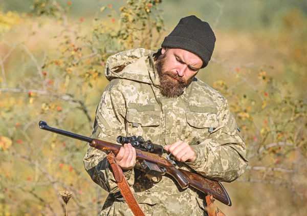 Man hunter with rifle gun. Boot camp. Military uniform fashion. Bearded man hunter. Army forces. Camouflage. Hunting skills and weapon equipment. How turn hunting into hobby. Please no.