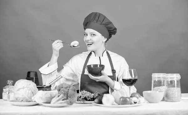 Eat healthy. Healthy ration. Woman professional chef hold spoon with raw mushroom. Dieting concept. Girl wear hat and apron try mushroom taste. Healthy vegetarian and vegan recipes. Healthy raw food