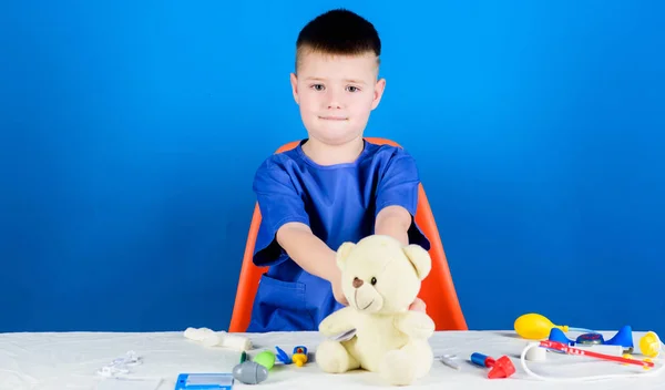 Medical examination. Medical procedures for teddy bear. Boy cute child future doctor career. Hospital worker. Health care. Medicine concept. Kid little doctor busy sit table with medical tools