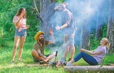 Yaz piknik katılın. Şirket sosis sopa üzerinde kavurma eğleniyor. Şenlik ateşi takılmak ve hazırlamak için toplantı arkadaşlar sosis aperatifler doğa arka plan kavrulmuş. Büyük piknik için toplama