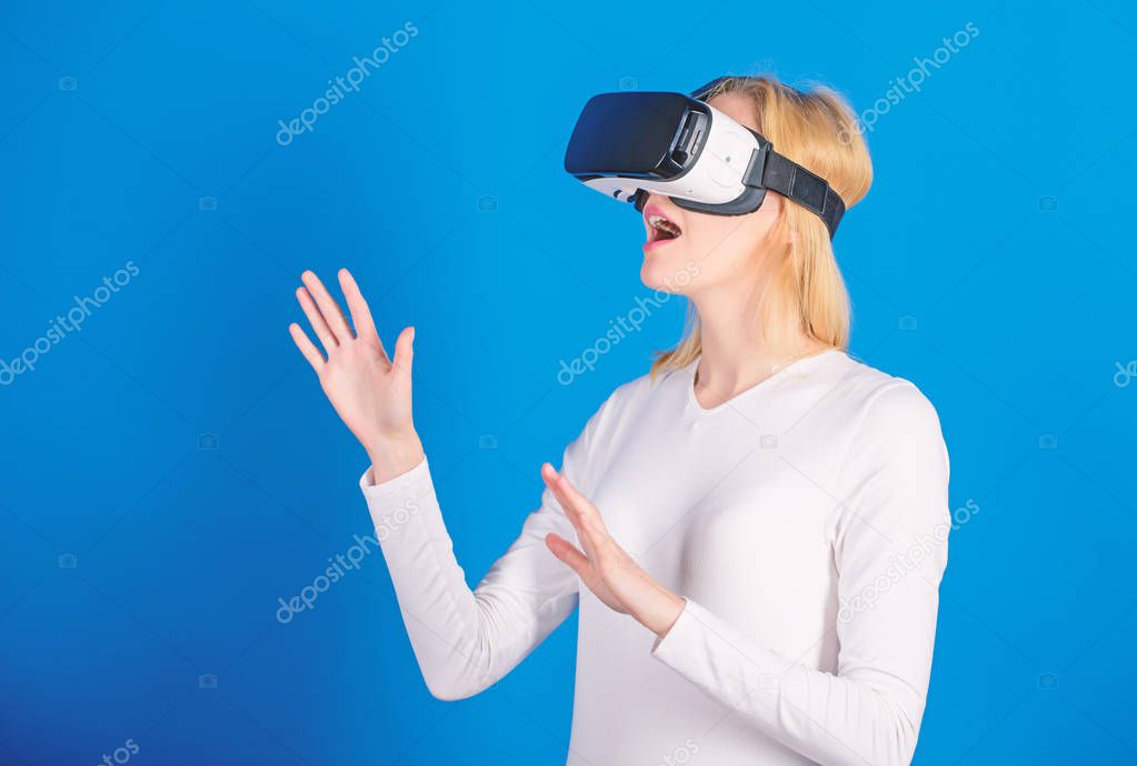 Young woman using a virtual reality headset with conceptual network lines. Woman using VR device. Cheerful smiling woman looking in VR glasses. Cyber.