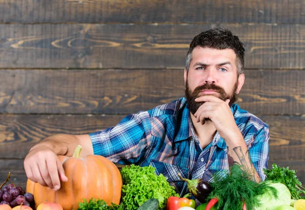 seasonal vitamin food. Useful fruit and vegetable. organic and natural food. happy halloween. man with rich autumn crop. harvest festival. bearded mature farmer. seasonal vegetables. seasonal food
