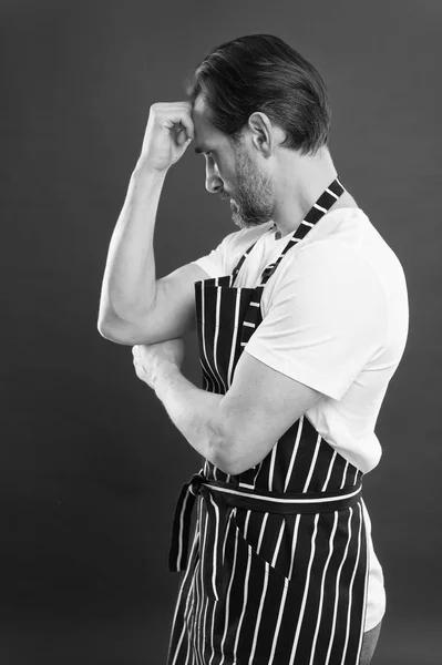 Confident mature handsome man in apron red background. He might be baker gardener chef or cleaner. Good in everything. Professional occupation. Apron for dirty work. Man in apron. Lot of work — Stock Photo, Image