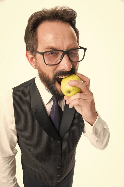 Businessman classic formal clothing and eyeglasses hold eat apple. Healthy vision sight nutrition tips. Best foods for eye health. Eye health concept. Tips eye health and maintaining good eyesight