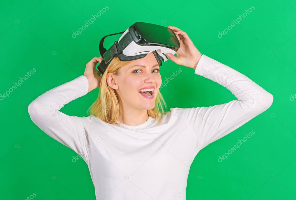 Excited smiling businesswoman wearing virtual reality glasses. Beautiful woman wearing virtual reality goggles in studio. Woman excited using 3d goggles. Digital VR.