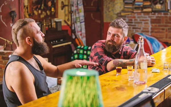 Men relaxing at bar. Strong alcohol drinks. Friday relaxation in bar. Opening hours till last visitors. Friends relaxing in bar or pub. Hipster bearded man spend leisure with friend at bar counter