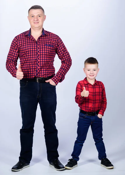 success. thumb up gesture. happy family. fathers day. childhood. parenting. father and son in red checkered shirt. little boy with dad man. Wild West is his heart. fatherhood is pure joy