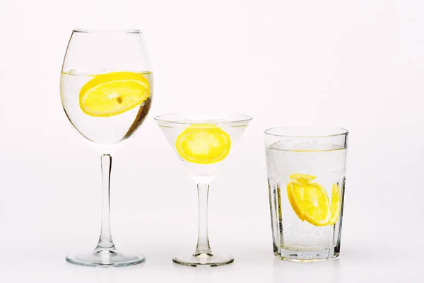 Detox drink to feel better. Hangover and detox. Detox after party. Health care concept. What to drink on party. Cocktail glasses with water slice of lemon isolated on white. Alcohol harmful influence — Stock Photo, Image