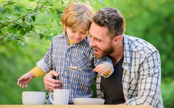 Childhood happiness. happy fathers day. Little boy with dad outdoor. healthy food and dieting. Family day. son and father eating milk porridge. Happy family together. Child development. love food — Stock Photo, Image