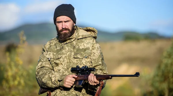 Hunting masculine hobby. Man brutal gamekeeper nature background. Bearded hunter spend leisure hunting. Hunter hold rifle. Focus and concentration of experienced hunter. Hunting and trapping seasons — Stock Photo, Image