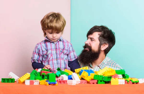 happy family. family leisure time. child development. building home with colorful constructor. father and son play game. happy little boy with bearded man dad playing together. happy family day