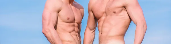 Sexy torso attractive body. Masculinity concept. Men twins brothers muscular guys sky background. Men strong muscular athlete bodybuilder. Attractive muscular twins. Muscular healthy athletic body