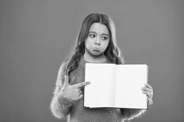 Sad news. Girl hold book orange background. Child show open pages of book or notepad. Book store concept. Free books available to read. Childhood literature. Development and education. Bad mark — Stock Photo, Image