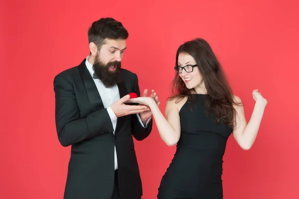 will you marry me. woman make bearded man proposal. formal couple. ring in box. valentines day. sexy couple in love. tuxedo man and elegant lady at engagement party. love date surprise. marry me