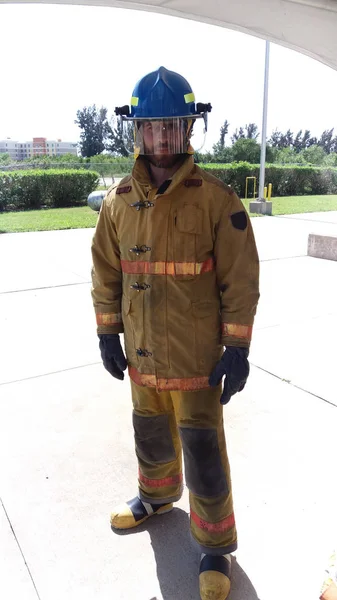 O meu trabalho é apagar incêndios. Em guarda. Bombeiro com uniforme e capacete. Masculinidade e trabalho masculino. Um dever masculino. Bombeiro bombeiro homem sério. Medidas de segurança contra incêndios. Bombeiro profissional — Fotografia de Stock