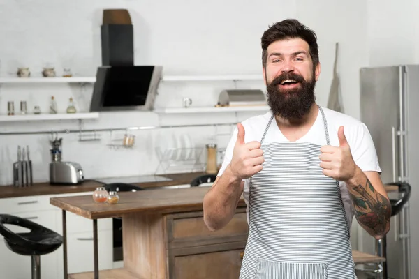Recommend nice recipe. Culinary business. Brutal confident chef in restaurant. Hipster bearded masculine chef cooking food in kitchen. Cuisine for real men. Cooking tasty food at home. Home food