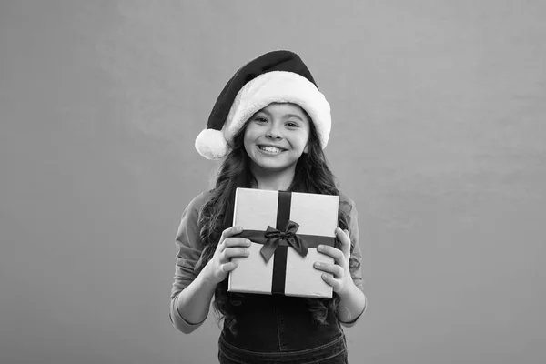 Happy winter holidays. Small girl. Little girl child in santa hat. New year party. Santa claus kid. Present for Xmas. Childhood. Christmas shopping. Christmas hope yours is all about the merry — Stock Photo, Image