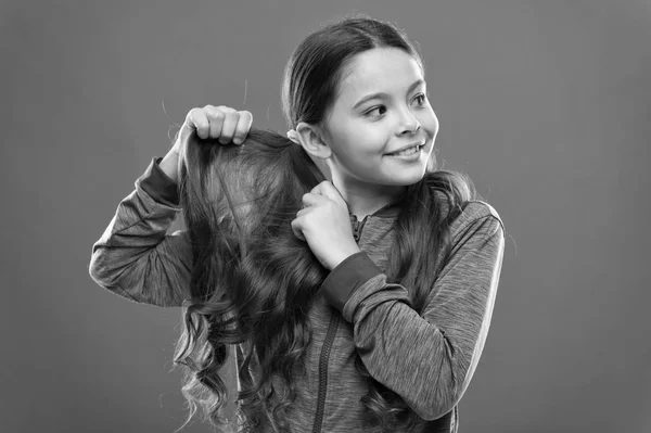 Charming beauty. Girl active kid with long gorgeous hair. Strong and healthy hair concept. How to treat curly hair. Easy tips making hairstyle for kids. Comfortable hairstyle for active lifestyle
