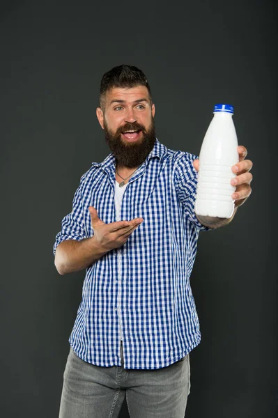 Milk products. Consuming lactose. Healthy nutrition. Yogurt probiotics and prebiotics. Bearded man hold white bottle with milk. Brutal caucasian hipster drink milk. Lactose diet. Health care and diet