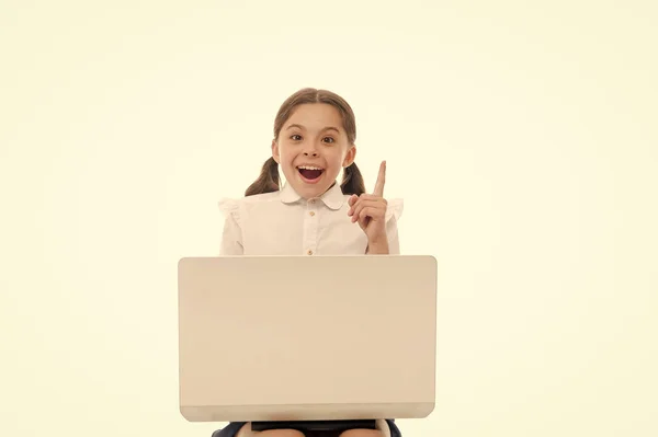 Kid point finger up isolated white. Schoolgirl with laptop pointing upwards. Schoolgirl having idea or recommend check this out. This direction. Subscribe or check. Push button turn on notification