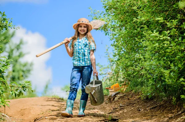 Little girl on rancho. summer farming. farmer little girl. garden tools, shovel and watering can. kid worker sunny. family bonding. spring country side village. future success. soils and fertilizers — Stock Photo, Image