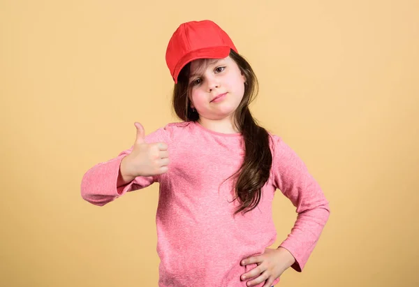 Thumbs up if you feel beautiful. Adorable girl showing approval hand gesture. Cute small child gesturing approval sign. Little kid expressing approval for clothing and accessory. Seal of approval