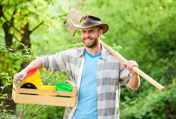 happy earth day. Eco living. Eco farm worker. Harvest. muscular ranch man in cowboy hat. farming and agriculture. Garden equipment. sexy farmer hold shovel and box with pot. I love gardening
