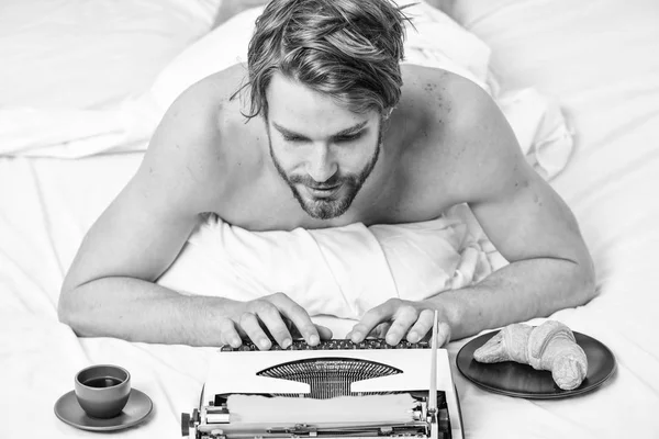 Writer handsome author used old fashioned manual typewriter. Man writer lay bed with breakfast working. Morning bring fresh idea. Morning inspiration. Erotic literature. Daily routine of writer