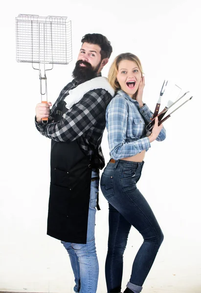 Family barbecue. Pretty woman and bearded man holding cooking grate. Happy couple using grid for cooking barbecue. Enjoy cooking barbecue food on grill. Joy of barbecue style of cooking