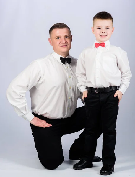 trust and values. patrician male fashion. happy child with father. business meeting party. father and son in formal suit. tuxedo style. little boy with dad businessman. family day. patrician concept