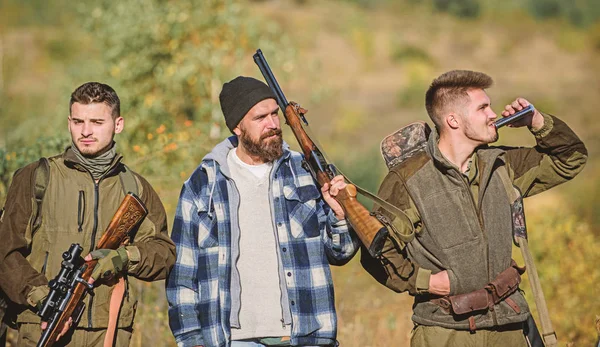 Hunters with rifles in nature environment. Illegal hunting. Hunters brutal poachers. Poacher partner in crime. Poaching concept. Activity for brutal men. Hunters poachers looking for victim — Stock Photo, Image