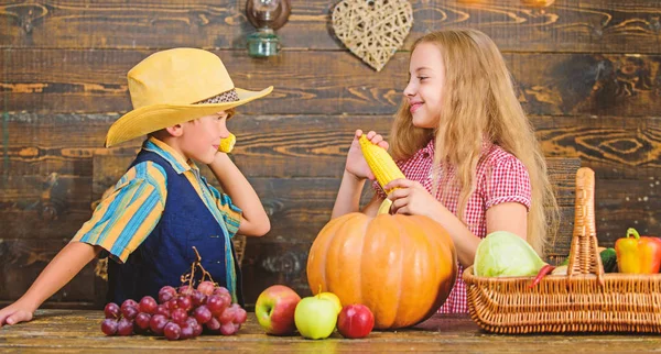 Reasons why every child should experience farming. Held responsible for daily farm chores. Kids farmers girl boy vegetables harvest. Family farm. Children presenting farm harvest wooden background