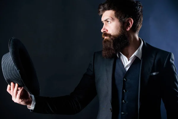 Man with hat. Vintage fashion. Man well groomed bearded gentleman on dark background. Male fashion and menswear. Formal suit classic style outfit. Elegant and stylish hipster. Retro fashion hat
