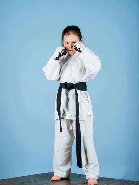 En knockout. energi och aktivitet för barn. En liten flicka i gympaskor. liten flicka i kampsport uniform. Övar på Kung Fu. Lycklig barndom. Idrottsframgångar i en enda strid. Stretching bort stress — Stockfoto