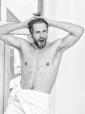 Maço seksi kaslı adam yatak odasının yanında dinleniyor. Sağlık ve refah kavramı. İyi hissediyorum. Güzel bir sabah rahatlaması. Sabahın tadını çıkarın. Harika bir gün. Maço sabah yatak odasında dinleniyor.