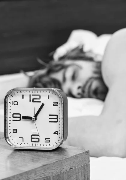 Homme ressentant des maux de dos dans le lit après avoir dormi. Étirez-vous après le réveil le matin. Portrait d'un homme dormant dans le lit à la maison . — Photo