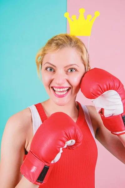 Athletic princess. Funny woman with crown prop in boxing gloves. Cute boxer girl with party prop. Athletic woman in sports wear. Sportswoman with princess look. Boxing is fun for her