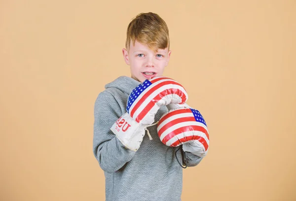 ΗΠΑ ημέρα ανεξαρτησίας. Ευτυχισμένο παιδί αθλητή σε γάντια του μποξ. προπόνηση του μικρού αγοριού μπόξερ. Punching νοκ-άουτ. Ικανοποιημένοι με το έργο του έξω. Γυμναστήριο. ενέργειας για την υγεία. Επιτυχία του αθλητισμού. αθλητικά μόδας — Φωτογραφία Αρχείου