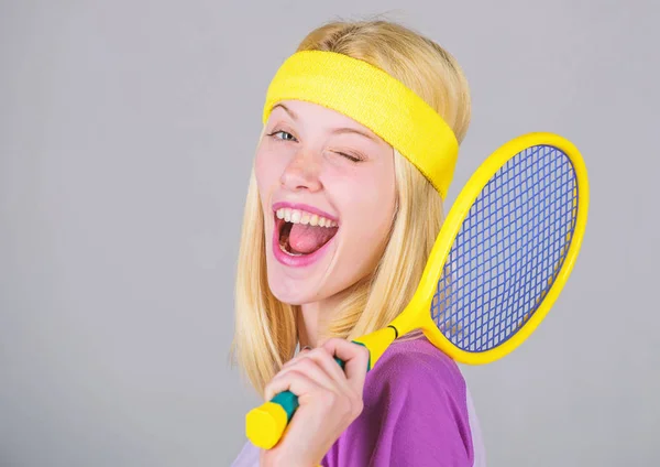 Sport for maintaining health. Athlete hold tennis racket in hand on grey background. Tennis club concept. Active leisure and hobby. Tennis sport and entertainment. Girl adorable blonde play tennis — Stock Photo, Image