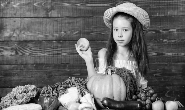 Girl kid farm market with fall harvest. Kid farmer with harvest wooden background. Family farm festival concept. Farm activities for kids. Traditional autumnal fest. Child celebrate harvesting — Stock Photo, Image
