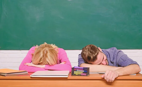 Feeling bored. Studying in college or university. Apply for free program. Couple friends student studying university. Student life issues. Guy and girl tired or lazy student lean on desk in classroom — Stock Photo, Image