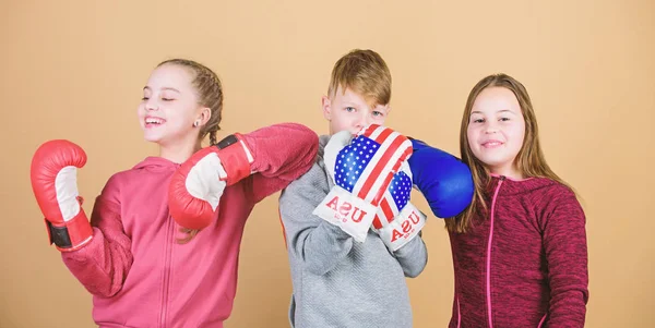 Happy children in boxing gloves. Fitness diet. energy health. punching knockout. Childhood activity. Sport success. Team fight. workout of small girls and boy boxer in sportswear. Pure perfection