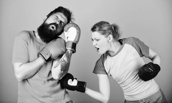 family fight. knockout and energy. couple training in boxing gloves. training with coach. Happy woman and bearded man workout in gym. sportswear. family problem. punching, sport Success. daily family