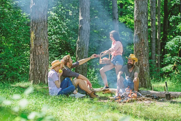 Friends enjoy picnic eat food nature forest background. Plan for perfect day hike picnic. Company friends or family relaxing picnic. Friends relaxing near bonfire. Pleasant hike picnic in forest