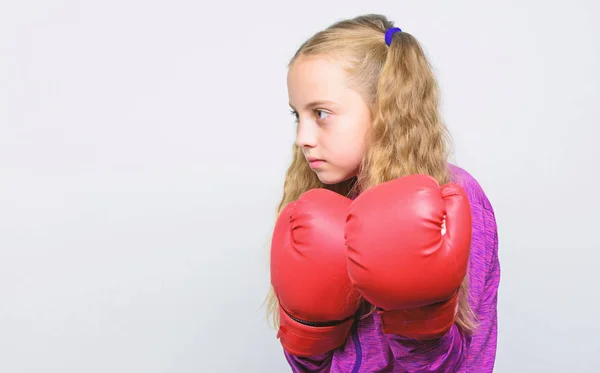 Cute kid with sport boxing gloves. Boxing sport for female. Sport upbringing. Skill of successful leader. Sport upbringing for leader. Girl cute child with red gloves posing on white background