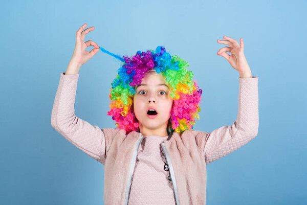 I am an artist and hair is my canvas. Cute little girl with fancy hair. Adorable small child wearing bright clown hair wig. Funny kid with curly synthetic hair