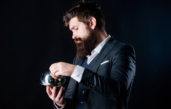 Waiter luxury restaurant. Man well groomed gentleman formal suit hold little cloche. Serving and presentation. Elite luxurious. Secret under cloche. Exclusive food hidden cloche. What is under cloche