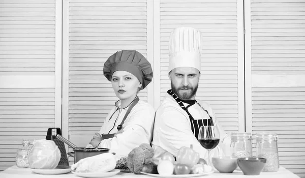 Reasons why couples cooking together. Cooking with your spouse can strengthen relationships. Woman and bearded man culinary partners. Ultimate cooking challenge. Couple compete in culinary arts