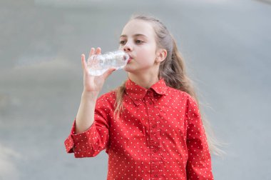 Su hayattır. Susamış çocuk plastik şişeden tatlı su içiyor. Küçük kız su şişesinden bir içki içiyor. Doğal mineraltemiz su ile susuzluğu giderme